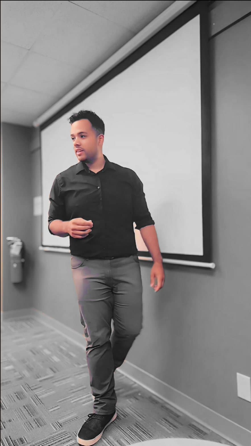 Dru Edwards standing in front of a classroom projection screen